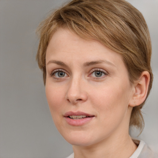 Joyful white young-adult female with medium  brown hair and blue eyes