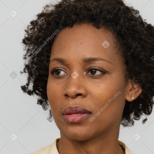 Joyful black young-adult female with medium  brown hair and brown eyes