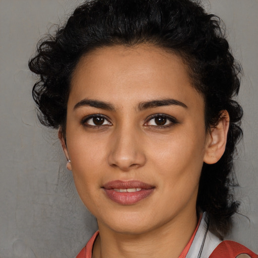 Joyful latino young-adult female with medium  black hair and brown eyes
