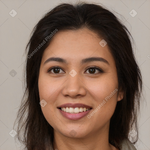 Joyful latino young-adult female with long  brown hair and brown eyes