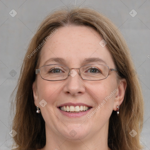 Joyful white adult female with long  brown hair and blue eyes