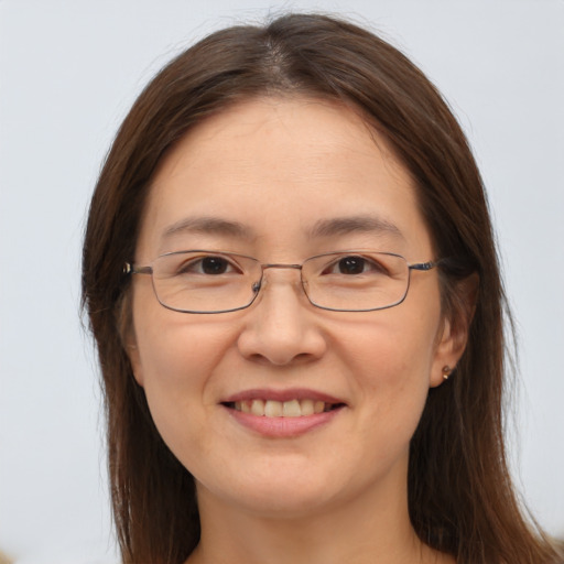 Joyful white adult female with long  brown hair and brown eyes