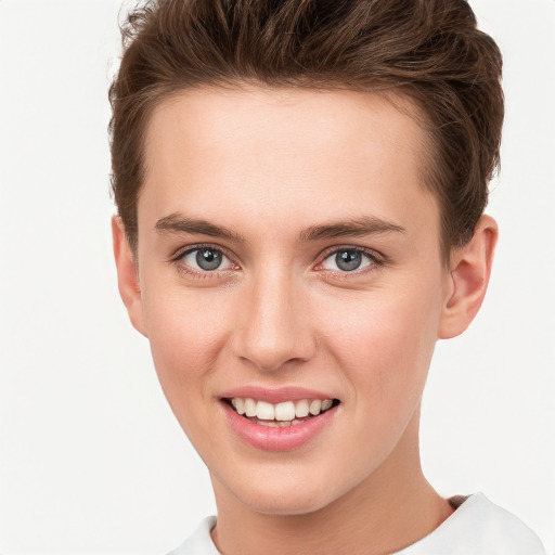 Joyful white young-adult female with short  brown hair and grey eyes