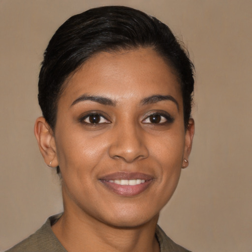 Joyful black young-adult female with short  brown hair and brown eyes