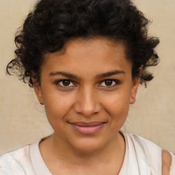 Joyful black child female with short  brown hair and brown eyes