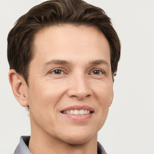 Joyful white adult male with short  brown hair and grey eyes