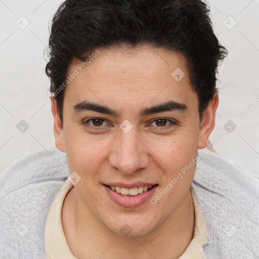 Joyful latino young-adult male with short  brown hair and brown eyes