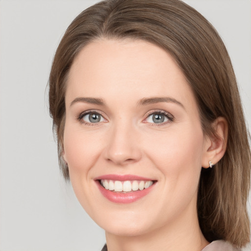 Joyful white young-adult female with medium  brown hair and green eyes