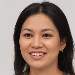 Joyful asian young-adult female with long  brown hair and brown eyes