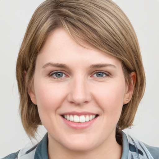 Joyful white young-adult female with medium  brown hair and blue eyes