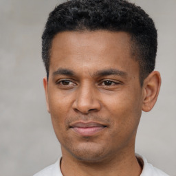 Joyful latino young-adult male with short  black hair and brown eyes