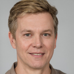 Joyful white adult male with short  brown hair and grey eyes