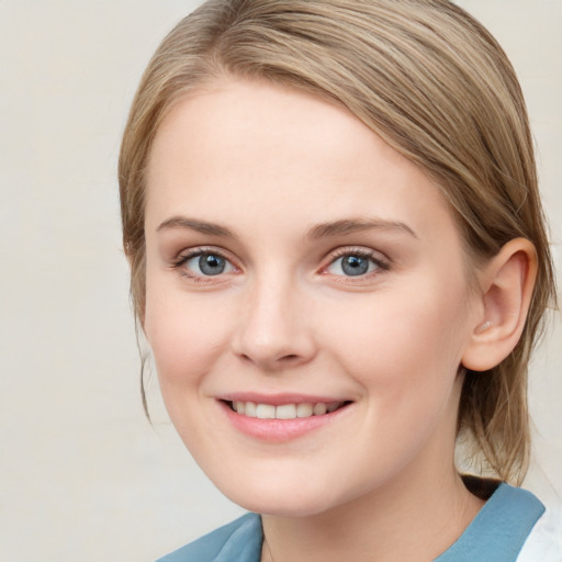 Joyful white young-adult female with medium  brown hair and blue eyes