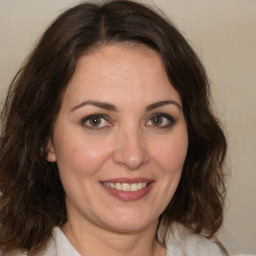 Joyful white adult female with medium  brown hair and brown eyes