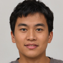 Joyful asian young-adult male with short  black hair and brown eyes