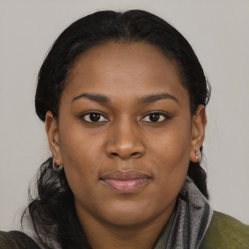 Joyful black young-adult female with medium  black hair and brown eyes