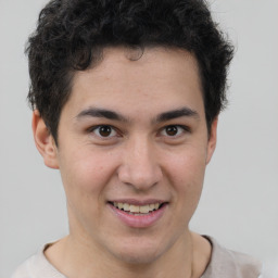 Joyful latino young-adult male with short  brown hair and brown eyes