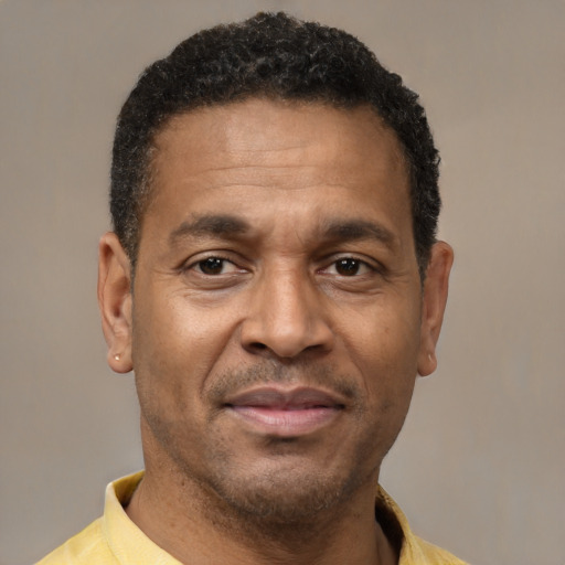 Joyful latino adult male with short  brown hair and brown eyes