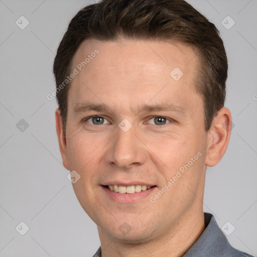 Joyful white young-adult male with short  brown hair and grey eyes