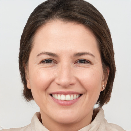 Joyful white adult female with medium  brown hair and brown eyes