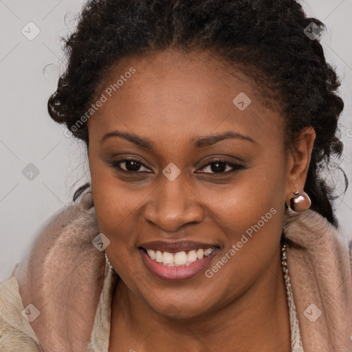 Joyful black young-adult female with long  brown hair and brown eyes