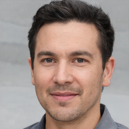 Joyful white adult male with short  brown hair and brown eyes