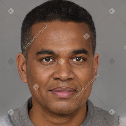 Joyful black adult male with short  brown hair and brown eyes