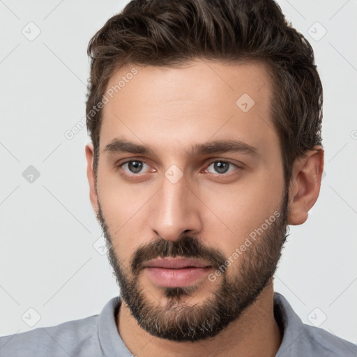 Neutral white young-adult male with short  brown hair and brown eyes