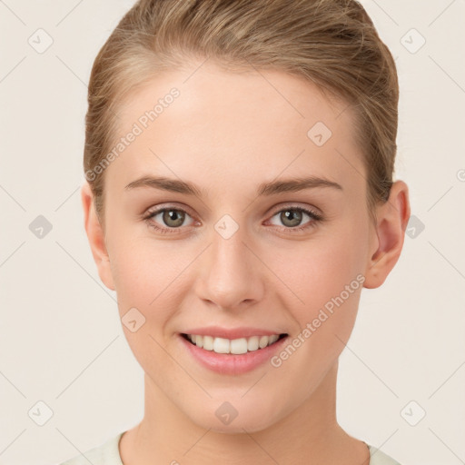 Joyful white young-adult female with short  brown hair and grey eyes