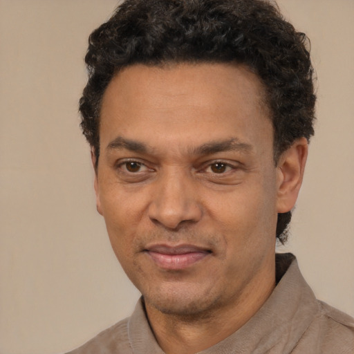 Joyful latino adult male with short  black hair and brown eyes
