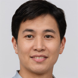 Joyful asian young-adult male with short  brown hair and brown eyes