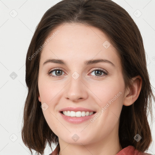 Joyful white young-adult female with long  brown hair and green eyes