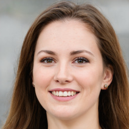 Joyful white young-adult female with long  brown hair and green eyes