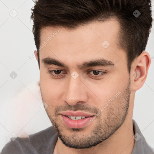 Joyful white young-adult male with short  brown hair and brown eyes