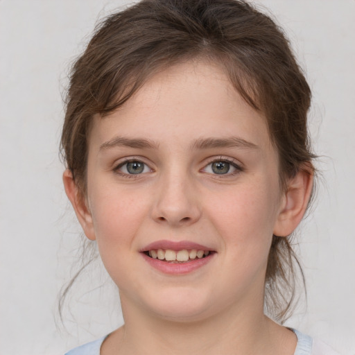 Joyful white child female with medium  brown hair and grey eyes