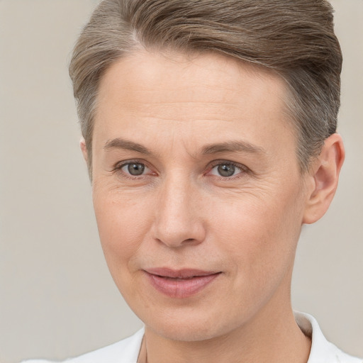 Joyful white adult female with short  brown hair and brown eyes