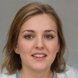 Joyful white young-adult female with medium  brown hair and blue eyes