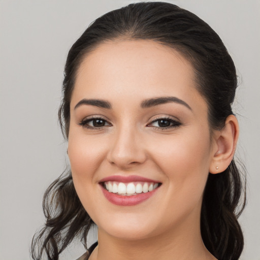 Joyful white young-adult female with long  brown hair and brown eyes