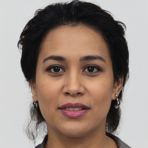 Joyful latino young-adult female with medium  black hair and brown eyes