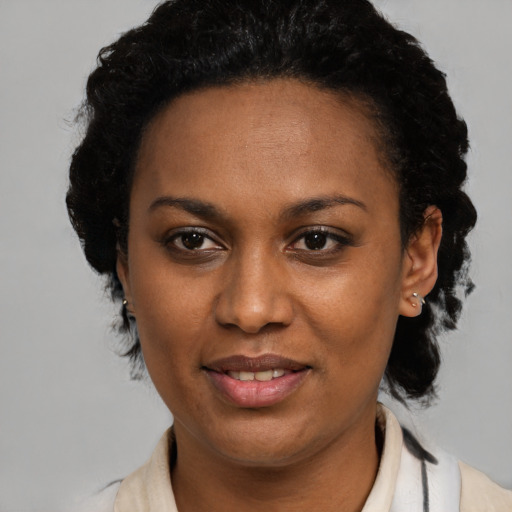 Joyful black young-adult female with medium  black hair and brown eyes