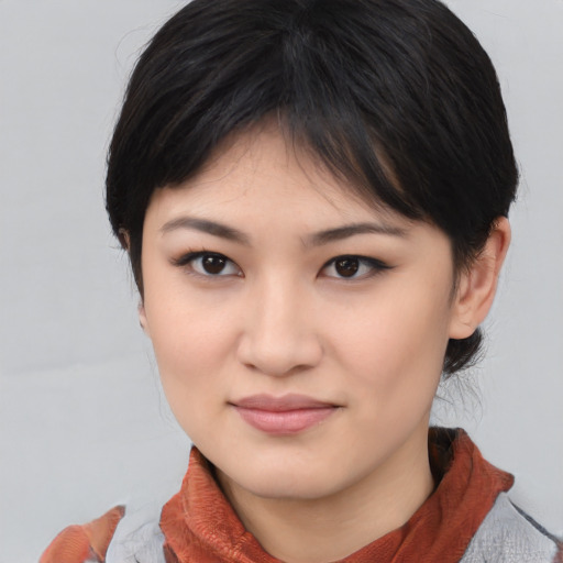 Joyful asian young-adult female with medium  black hair and brown eyes