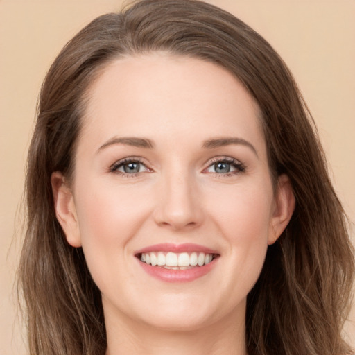 Joyful white young-adult female with long  brown hair and green eyes