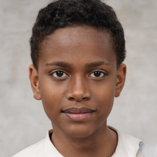 Joyful black child male with short  brown hair and brown eyes