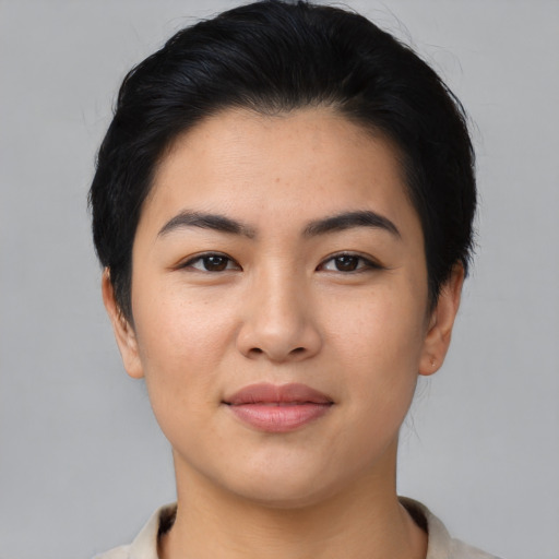 Joyful asian young-adult female with short  black hair and brown eyes