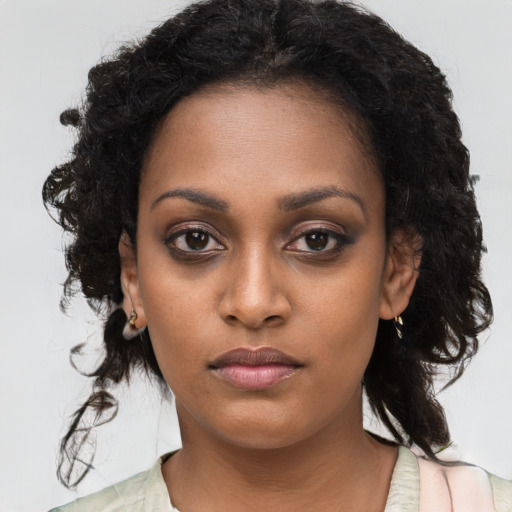 Neutral black young-adult female with long  brown hair and brown eyes