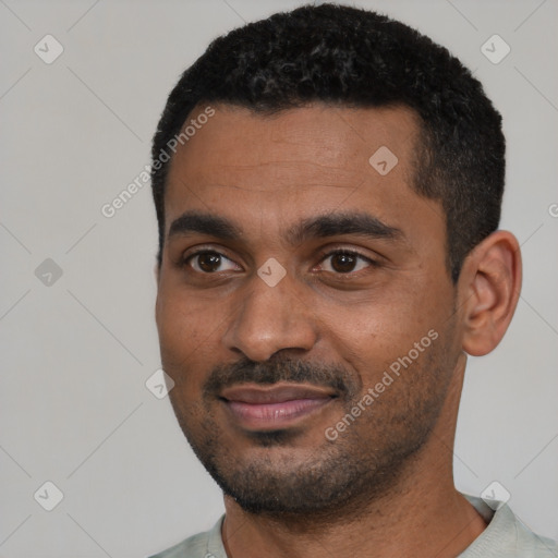 Joyful black young-adult male with short  black hair and brown eyes