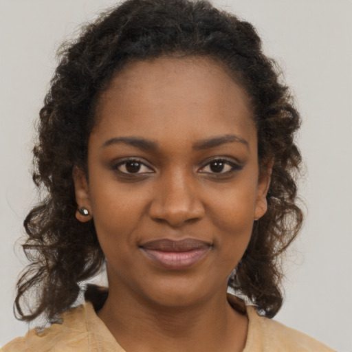 Joyful black young-adult female with medium  brown hair and brown eyes