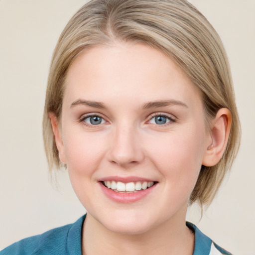 Joyful white young-adult female with medium  brown hair and blue eyes