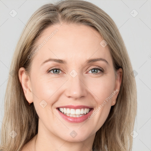 Joyful white young-adult female with long  brown hair and blue eyes