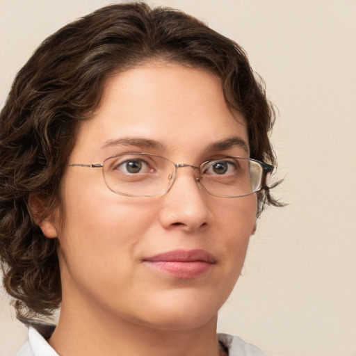 Joyful white adult female with medium  brown hair and green eyes